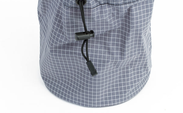 The pull string and compressing closure clip of the Yarn Stuff Sack, this one in Northwest Sky (light grey with white grid) 200 Halcyon.